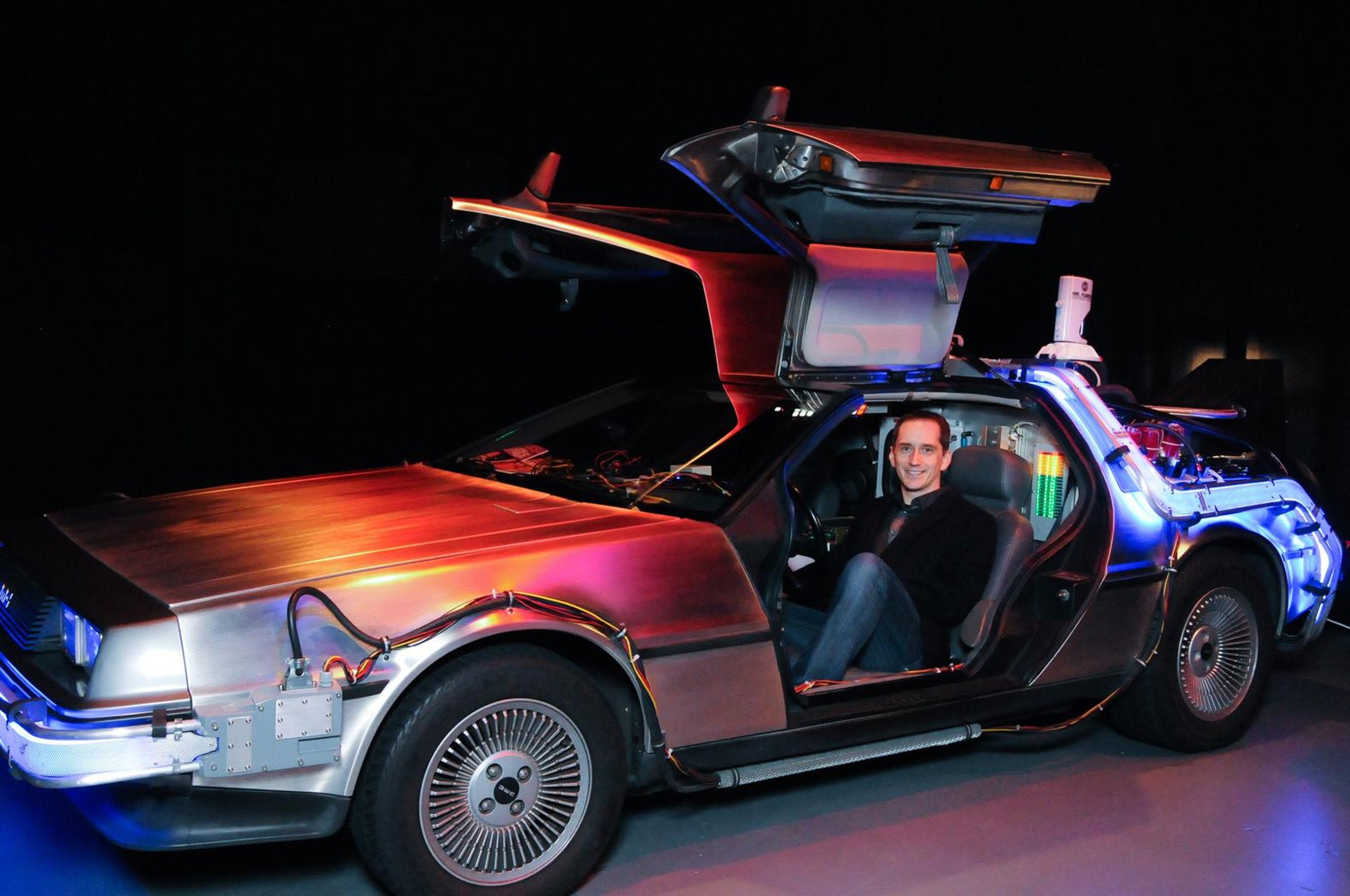 Garett Nell standing beside a classic car in Seattle.